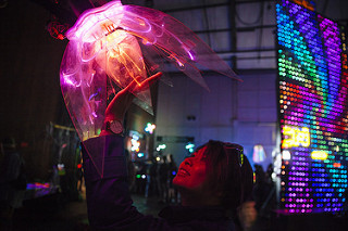 A woman touches a light sculpture at the Bay Area Maker Faire.