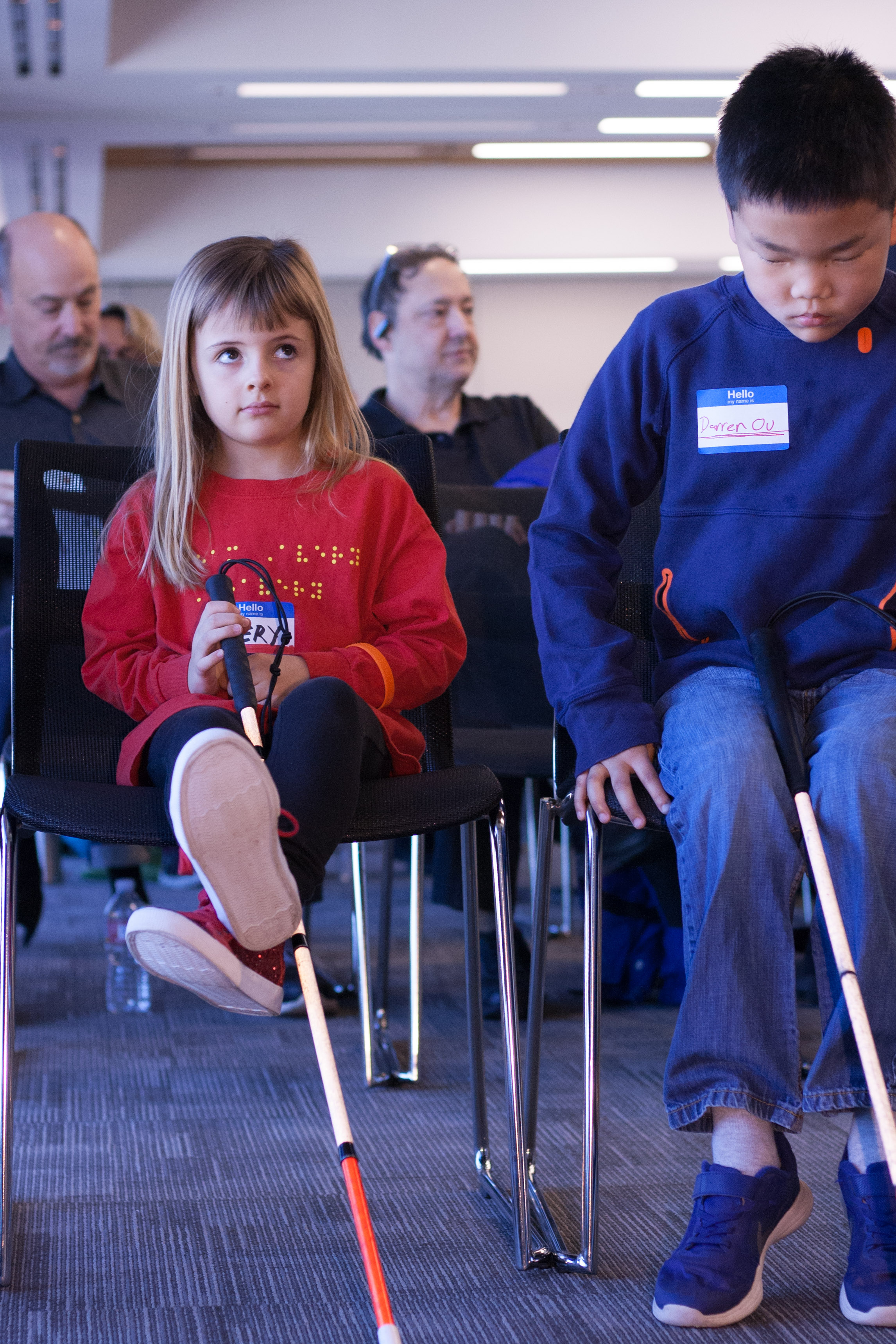 Braille Challenge competitors Avery and Darren sit in the front row listening to opening remarks.