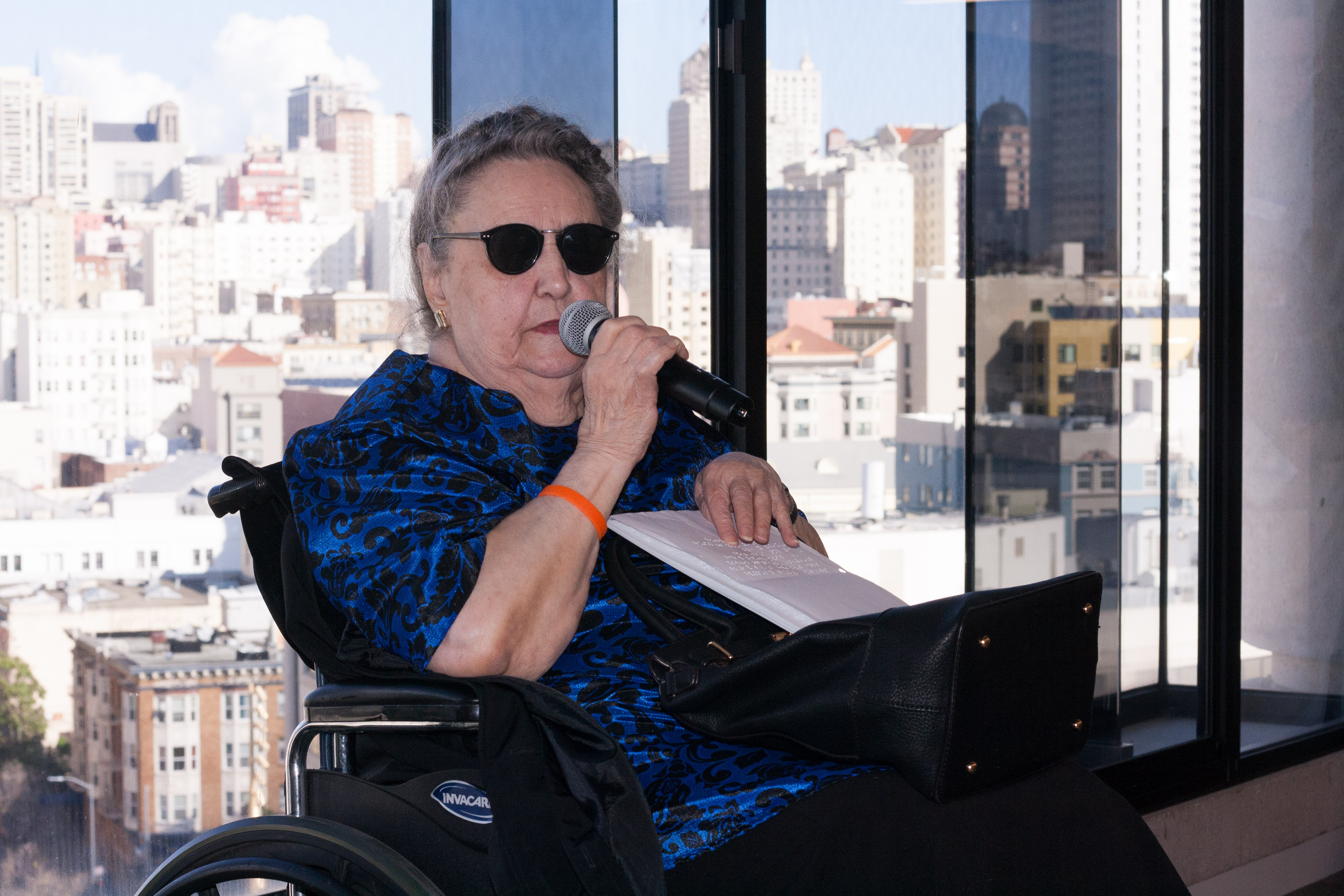 92-year-old Cathy Skivers gives her opening remarks about the importance of braille literacy.