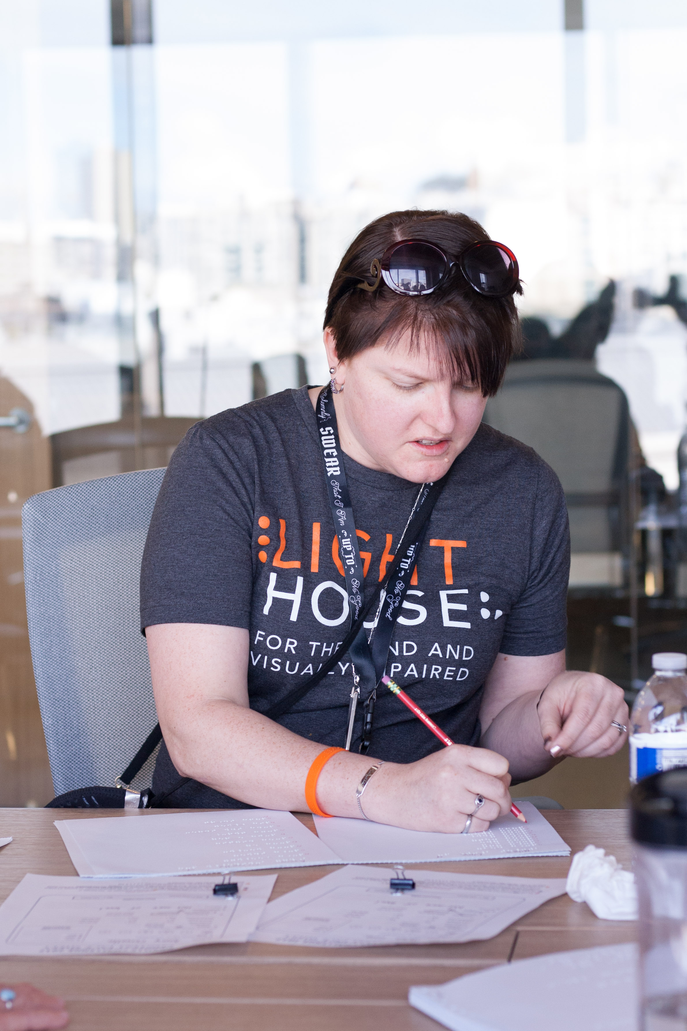 LightHouse employee BJ Epstein helps check the kids' tests behind the scenes.
