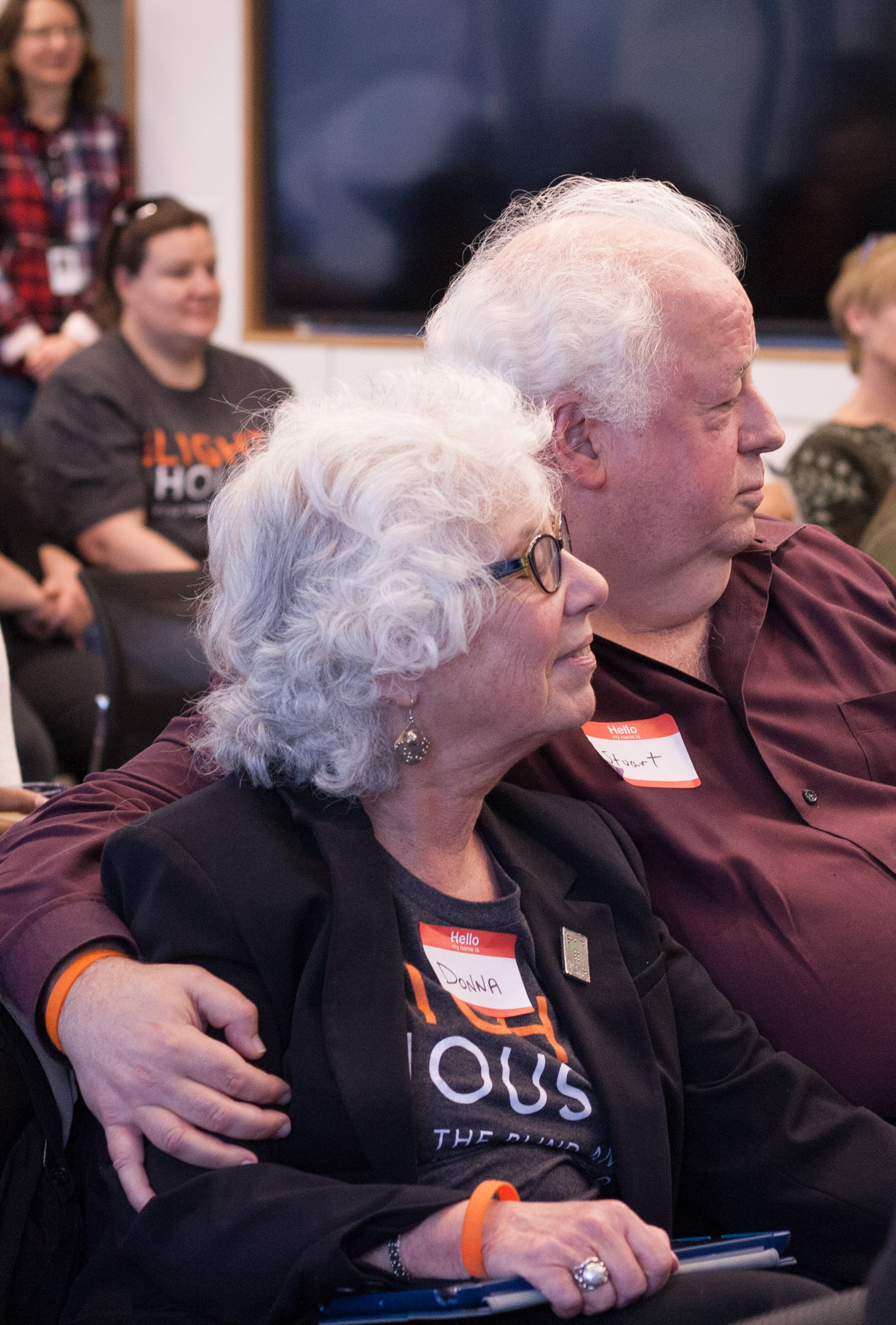 Stuart (formerly of California School for the Blind) and proctor Donna sit close while listening to closing remarks.