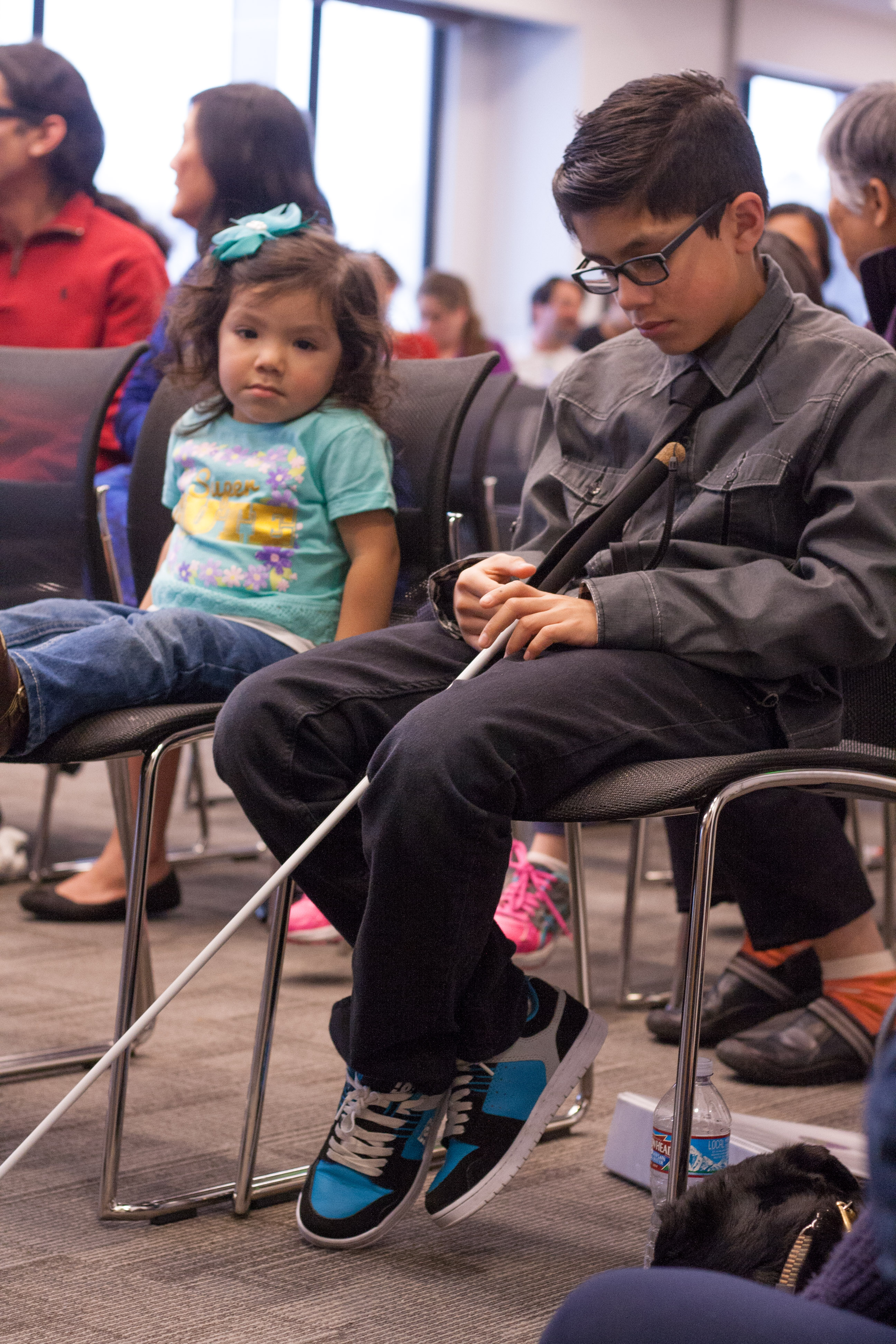 Sophomore competitor Alejandro sits next to his little sister in the multipurpose rooms.