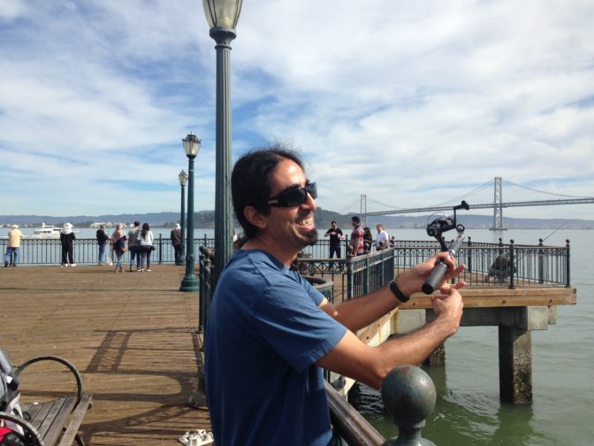Ahmet Ustunel smiles holding a fishing pole