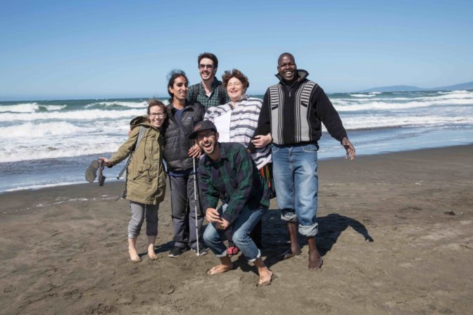 The 2017 Holman Prizewinners smile with the Holman Team on Ocean Beach during Welcome Week.