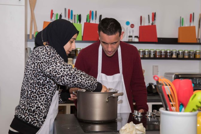 Jamila and Andy mix the fudge in a pot while waiting for it to heat.