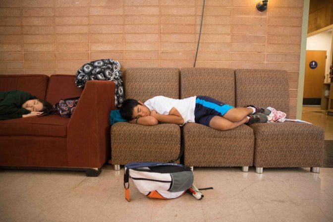 Two campers rest on the couches in the dining hall during a mid-morning break.