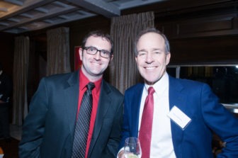 A pair of Gala attendees smile stand, smiling with delight.