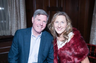 A pair of Gala attendees sit, smiling.