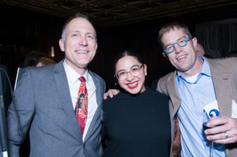 A trio of Gala attendees stand smiling.