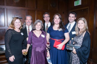 A large group of Gala attendees stand smiling.