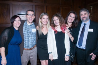 A group of six Gala attendees stand, smiling.