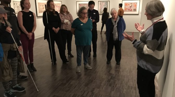 As a Museum Meanderings at the Asian Art Museum, a docent explains more about an exhibit to a group of LightHouse participants.