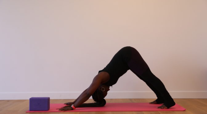 LightHouse Health and Wellness Program Coordinator Amber Sherrard doing downward dog, an inversion pose.