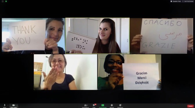 A screenshot of a Zoom session with LightHouse Staffers holding up papers that say “Thank You” in various languages.