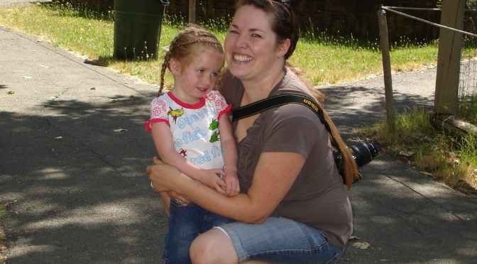 A women holds a young child outdoors