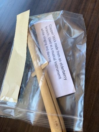 A replica of a clapper stick, a musical instrument