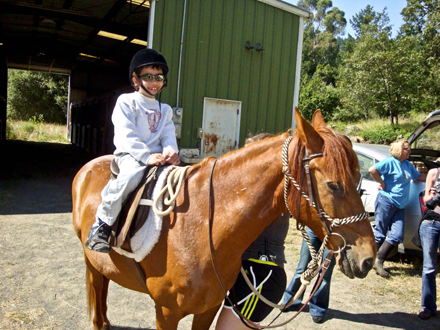 An Enchanted Hills Camper sits atop his horse