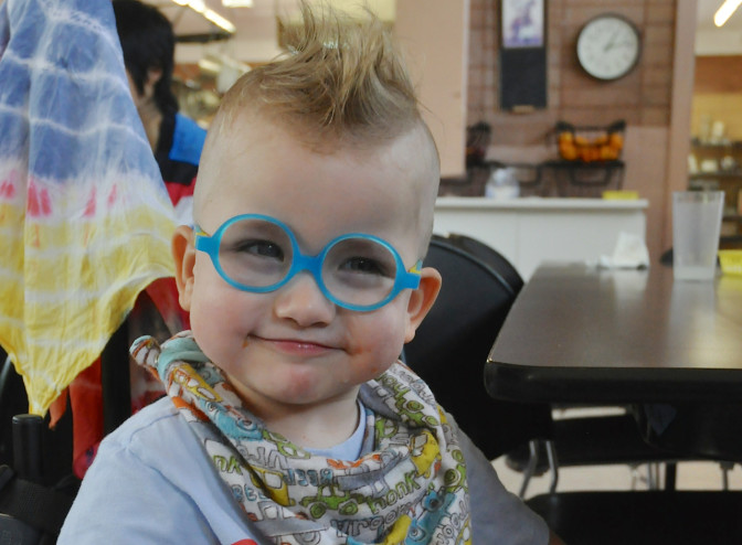 Coltrane looks classically charming in his baby-blue-rimmed spectacles