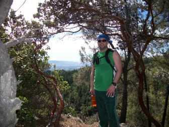Ready to hike - Masceo Williams stands under the trees at Enchanted Hills