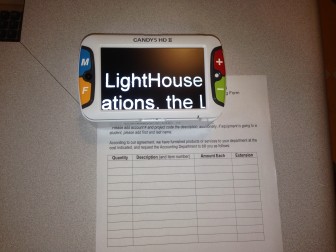 The CANDY 5 magnifier enlarges the word LightHouse, on a form placed under it
