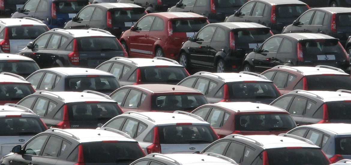 An aerial photo of automobiles in a sales lot.