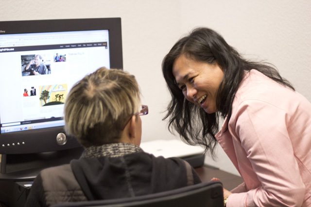 Divina Carlson works with student at computer