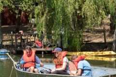 A group of teens fish on the lake Lakoya at EHC in a small boat during Teen Session 2018.