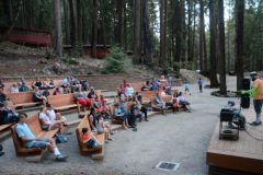 A side view of a crowd listening to music in the Redwood Grove Theater at EHC.