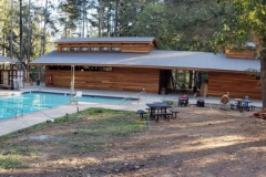 The pool area and rebuilt pool bathhouse clad in our own redwood siding.