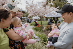 Two parents holding their babies next to each other