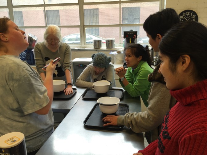 Students in our Cooking 101 class, mixing bowls at the ready, stand at their counters waiting to put a recipe together.